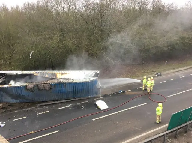 Wreckage being hosed by fire officers