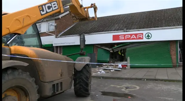 JCB digger by the crumbling Spar which was used to take the cash machine