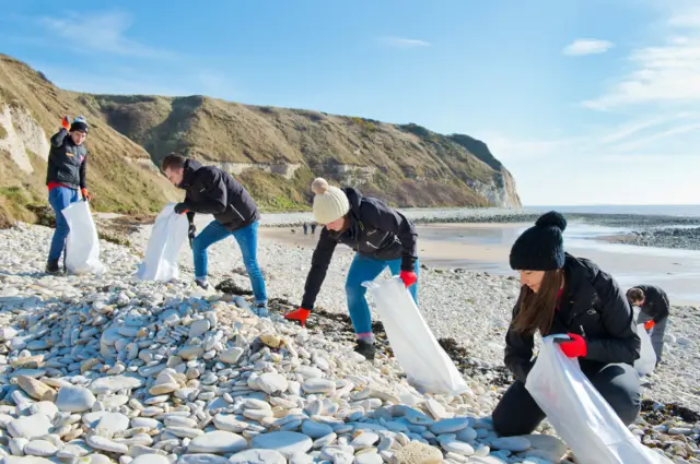 kids collecting pebbles