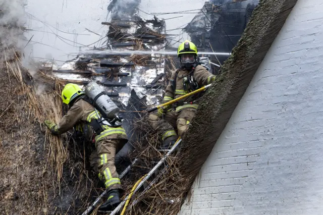 Firefighters tackling thatch cottage fire