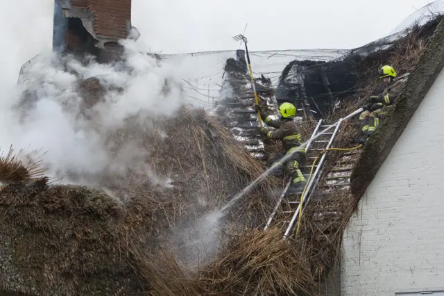 Firefighters tackling thatch cottage fire