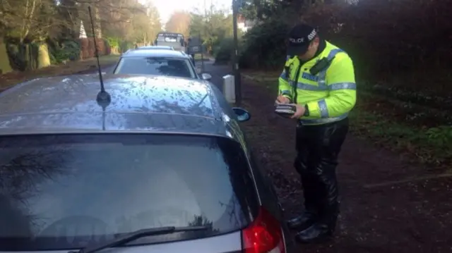 Officer outside a car