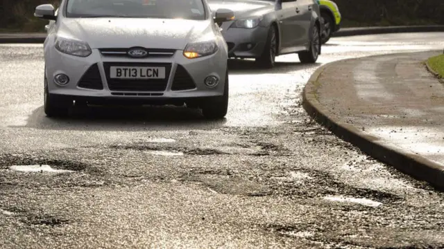 
          Potholes in the road at Five Ways Island, Heath Hayes, Cannock
        