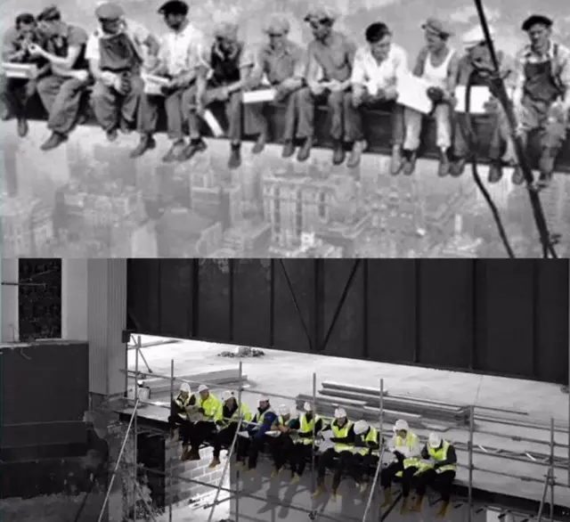 Construction workers perch on stage for picture