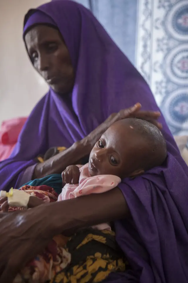 Woman holds child