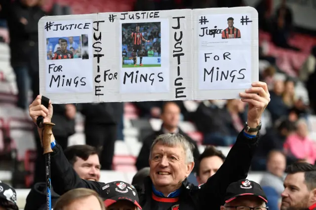 Fans hold signs up about Tyrone Mings