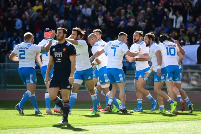 Italy's players celebrate scoring the opening try