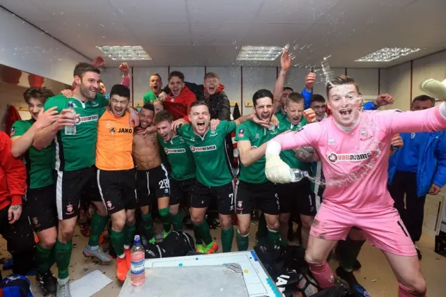 Lincoln celebrate their FA Cup win at Burnley