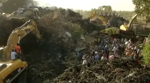 
          Excavators work after a landslide at a garbage dump on the outskirts of Addis Ababa, Ethiopia in this still image taken from a video from March 12, 2017
        