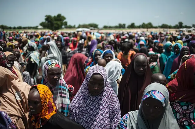 
          Large crowds gather to receive supplied at the camp for internally displaced persons in Muna
        