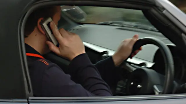 Man on mobile phone in car