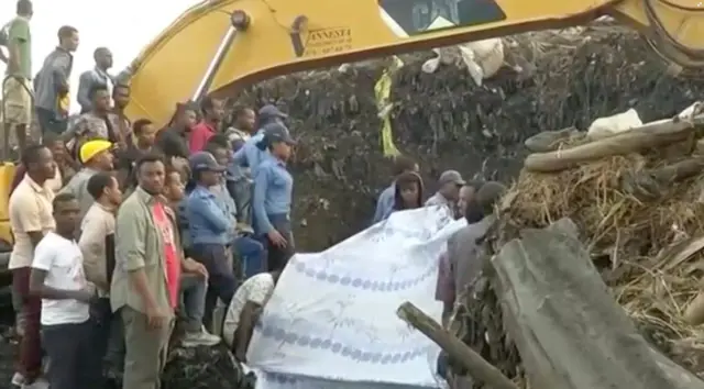 people at site of landslide