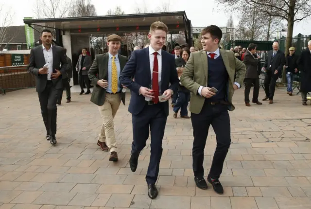 People walk through gates