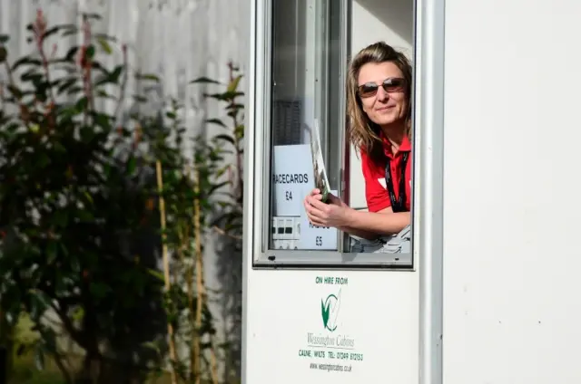 Woman selling programmes