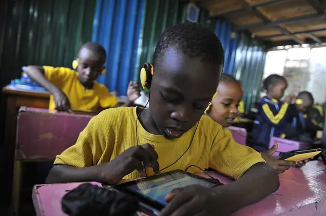 
          Pupils from Light House Grace academy use the Kio tablet created by the local technology company BRCK Education during a class sesssion in Kawangware, Nairobi
        