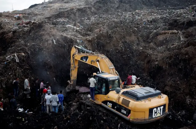 Digger at rubbish site