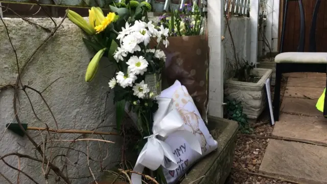 Flowers near the house where the mother and baby died