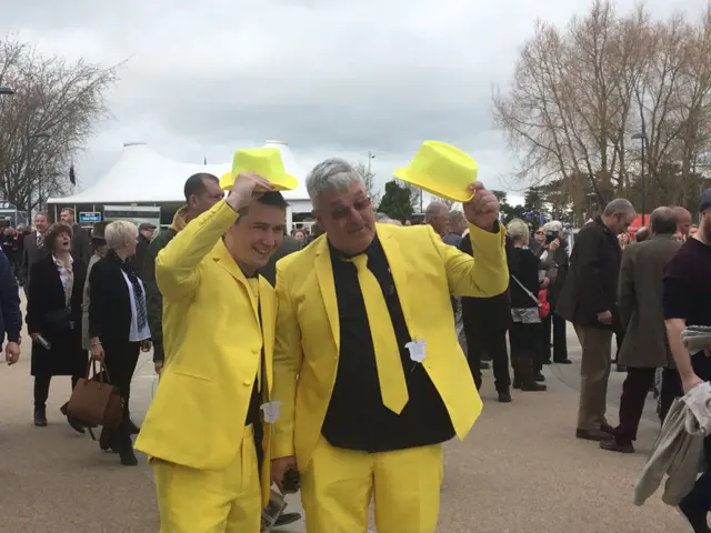 Men dressed in yellow suits