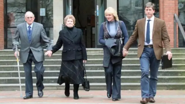 
          Kenneth Hugill, a farmer cleared of shooting a burglar, leaves court with his family
        