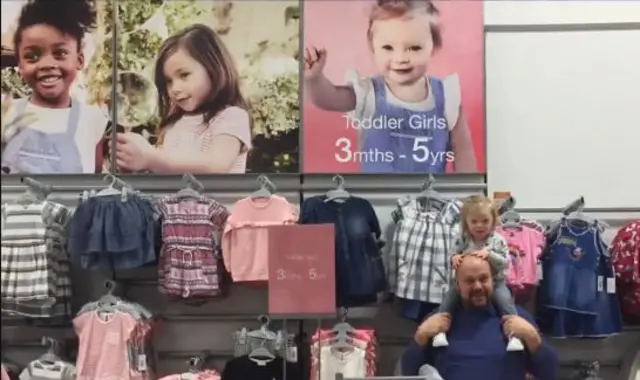 Lily and her Dad in Matalan in front of Lily's poster