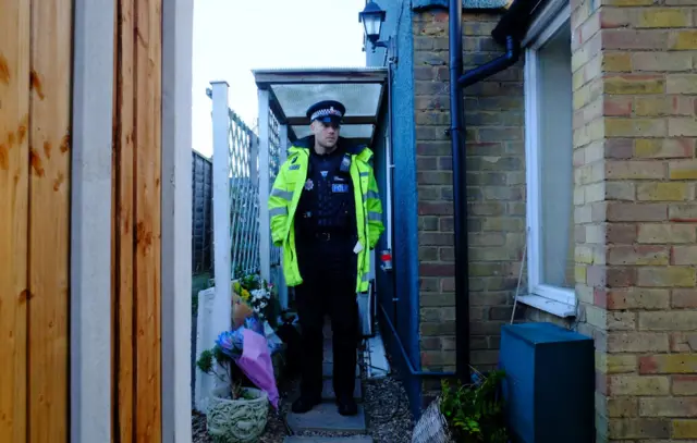 Police officer outside the house in Brentwood