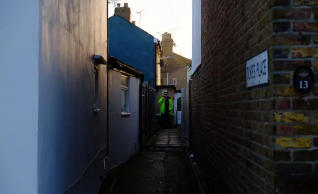 Policeman outside family home