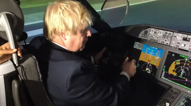 Boris Johnson in a cockpit of a flight simulator