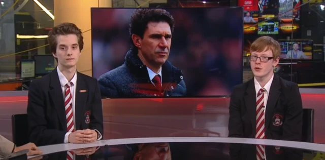 Two pupils present the sports news