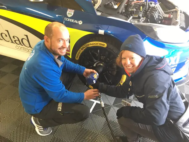 
          Helen McCarthy using an air gun to change a tyre on Team Parker’s car
        