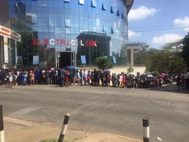 Queue snakes round the corner outside Kenyan media building