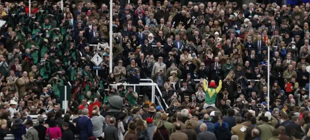 
          Sizing John and jockey Robbie Power in front of the Cheltenham crowd
        