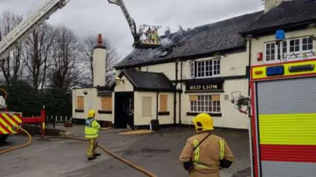 Fire crews yesterday tackling fire at Red Lion in Bucknall