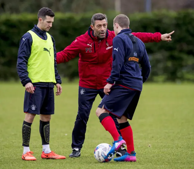 
          New Rangers manager Pedro Caixinha (centre) issues instructions to Jason Holt and Liam Burt
        