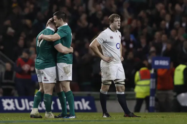 Joe Launchbury looks dejected as Jonny Sexton celebrates