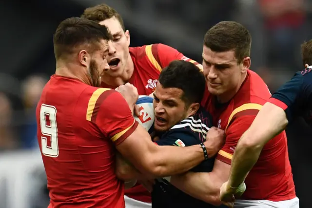 Wales players tackle Fabien Sanconnie