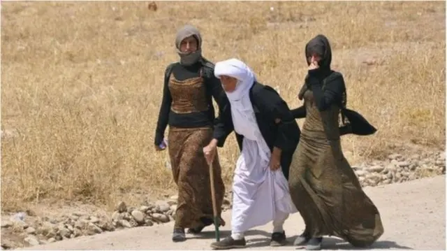 Old man with Yazidis women