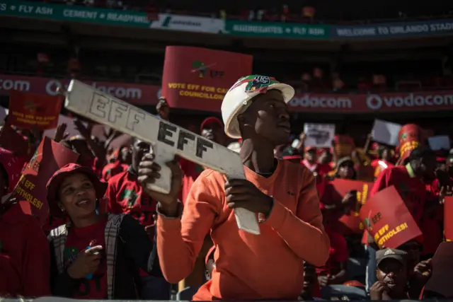 
          South African opposition radical party Economic Freedom Fighters supporter holds a EFF sign during the official local election manifesto launch at Soweto's Orlando Stadium in Johannesburg on April 30, 2016
        