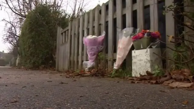 Flowers at scene where couple were found dead inside a car