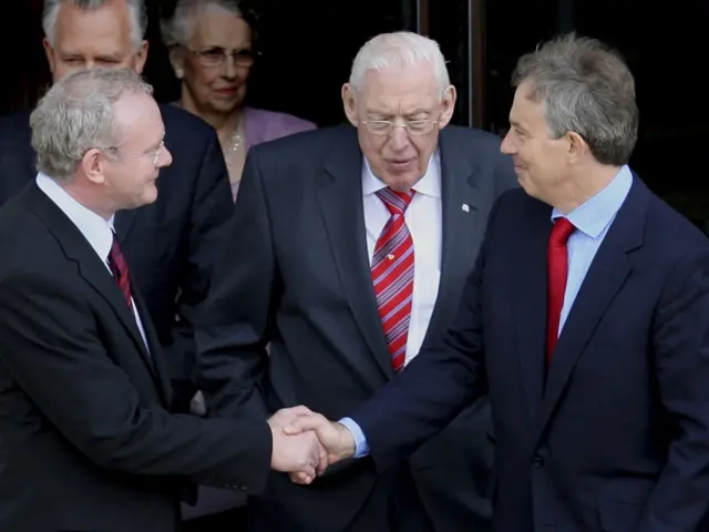 
          Martin McGuinness, left, shakes hands with Britain's former PM Tony Blair in 2007
        