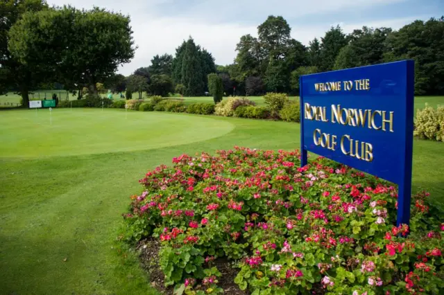 
          Sign for the Royal Norwich Golf Club, positioned in flower bed by greenway
        