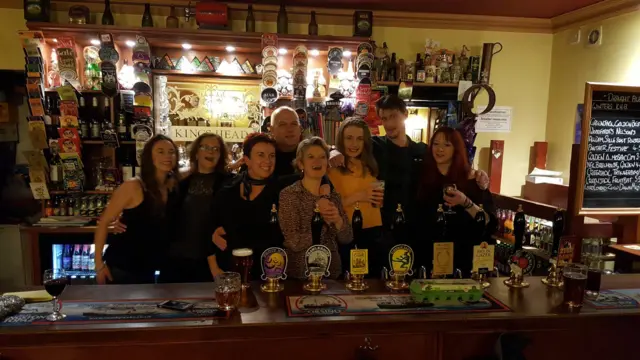 The team of the King's Head, behind the bar