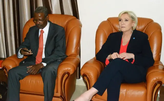 
          French far-right Front National (FN) party candidate for the presidential election Marine Le Pen (R) sits next to Chadian president cabinet director Mahamat Hissein at the N"Djamena airport on March 21, 2017
        