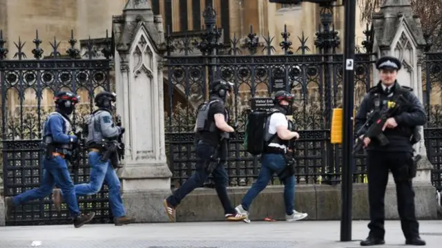 Armed police were seen running towards the palace