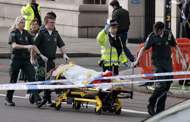 
          Emergency services transport an injured person to an ambulance
        