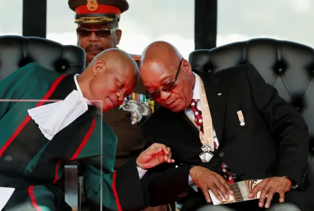 
          South African President Jacob Zuma (R) listens to Chief Justice Mogoeng Mogoeng ahead of Zuma"s inauguration ceremony at the Union Buildings in Pretoria May 24, 2014.
        