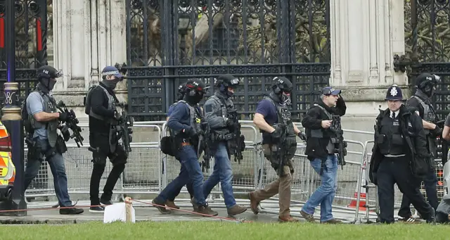 Armed officers enter the Houses of Parliament