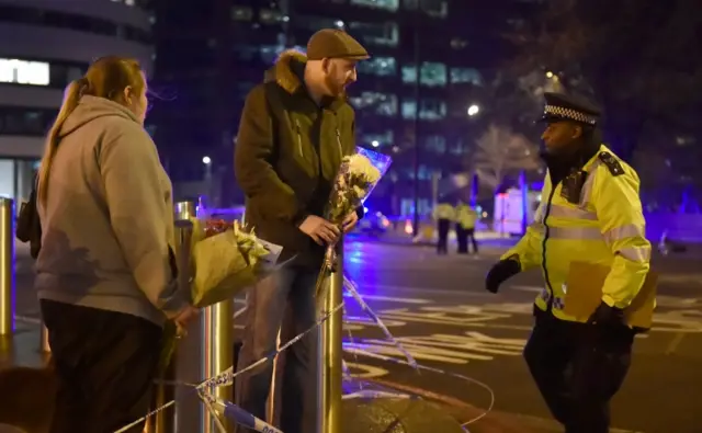 People laying flowers in Westminster