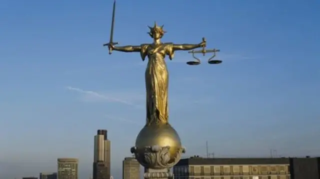 
          Statue of the Scales of Justice on the rooftop of the Old Bailey building
        