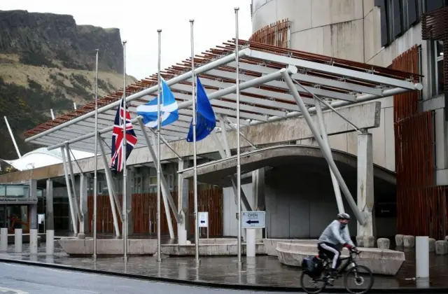 
          Flags fly at half-mast outside the Scottish Parliament building in Holyrood
        