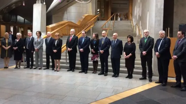 
          The first minister joined MSPs for a minute's silence as the parliament opened on Thursday morning
        